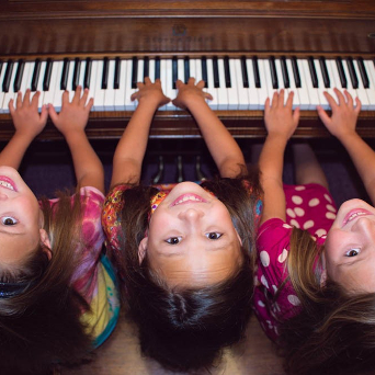 triplets practicing piano